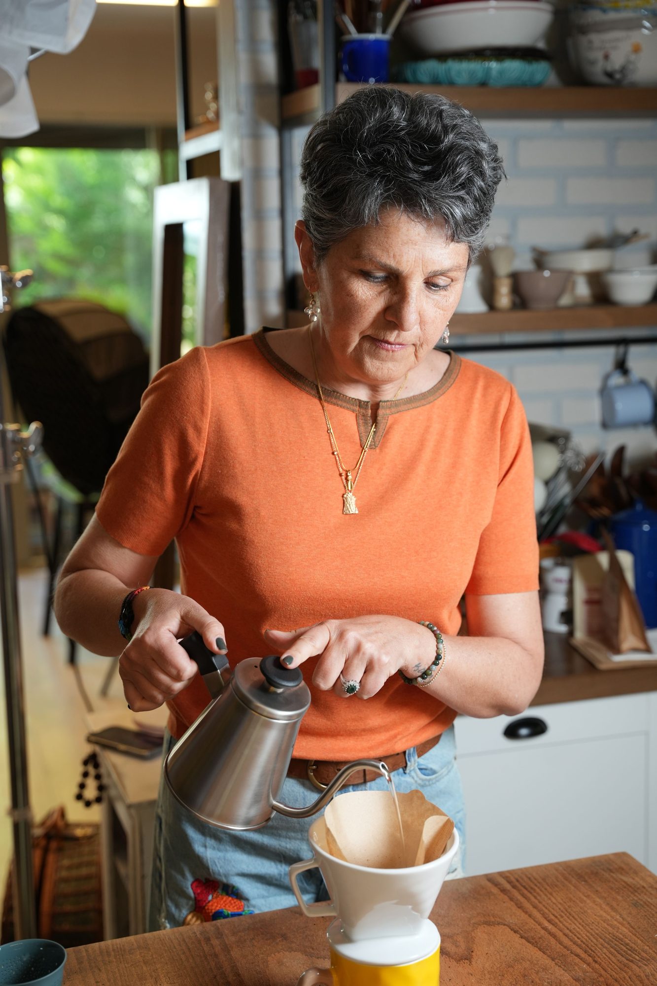 An ordinary camera view of Mom in her kitchen in the morning