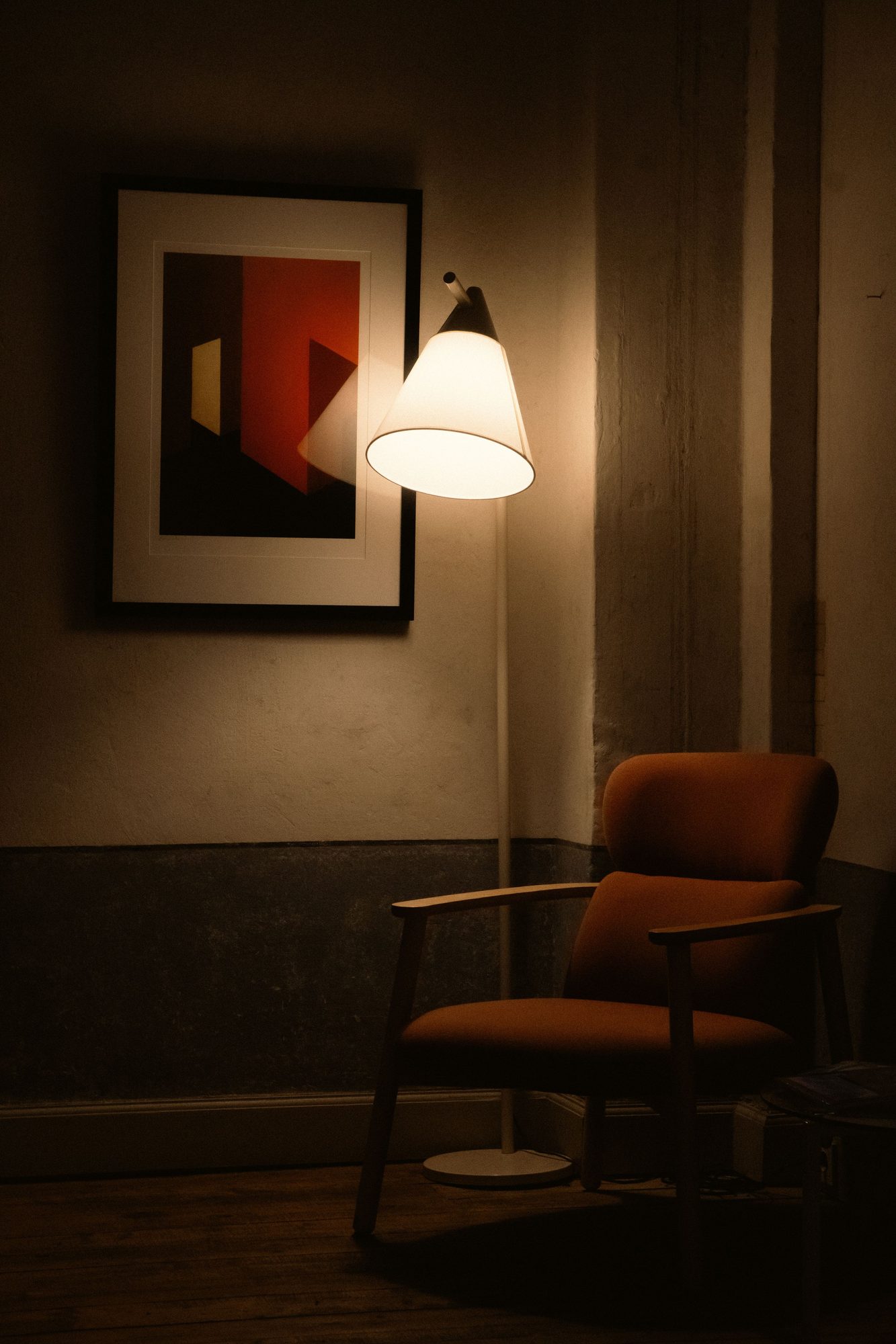 An armchair under a warm wall lamp in the room where Remy flagged a moment worth a look