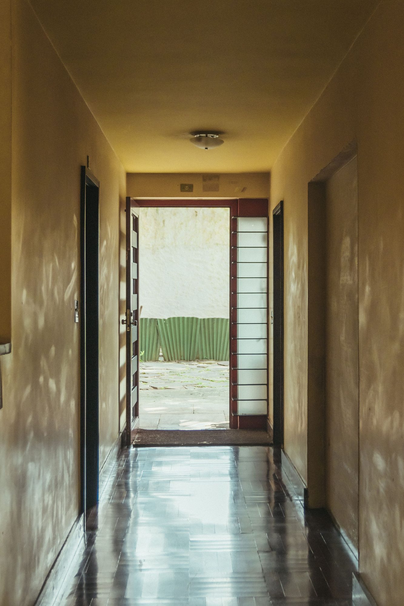 Light falling through an open doorway onto a hallway floor